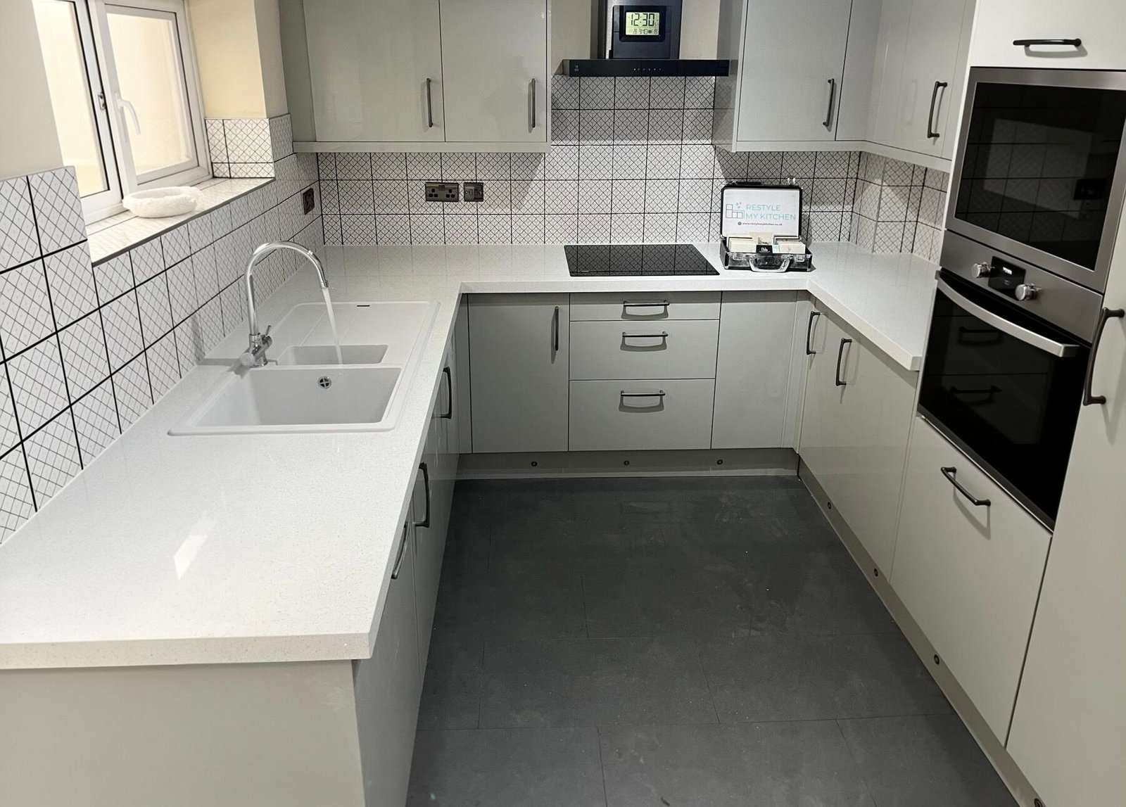 - Kitchen worktop overlay installed around sink and hob