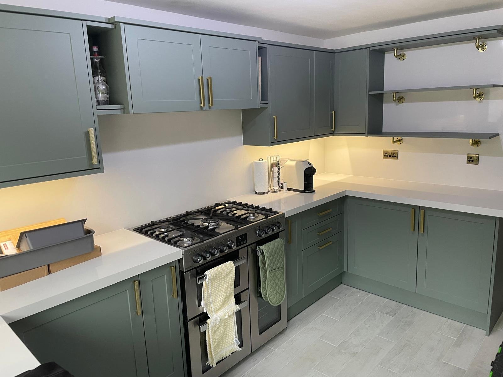 Sage green shaker kitchen doors with brass handles